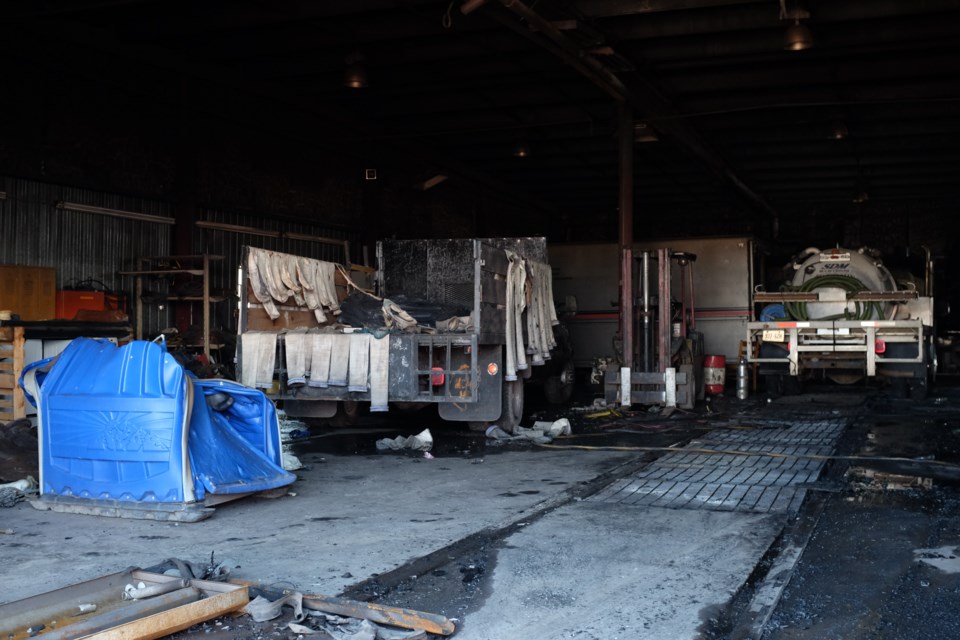 Melted and burned porta-potties, damaged vacuum trucks, and extensive building damage remained after a Sunday-night fire at Industrial Services & Management. Photo by Jeff Klassen for SooToday