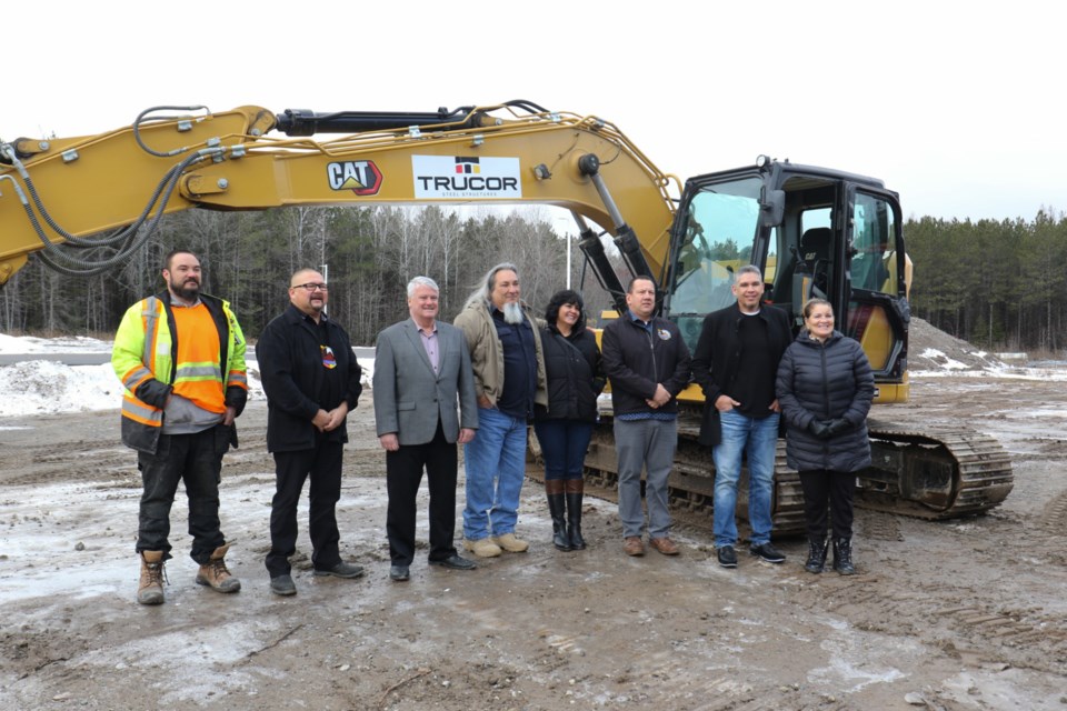 First Nations leadership and FedNor employees pose for a photo in front of a new excavator Trucor acquired with the help of $442,000 in federal funding announced Dec. 18.   