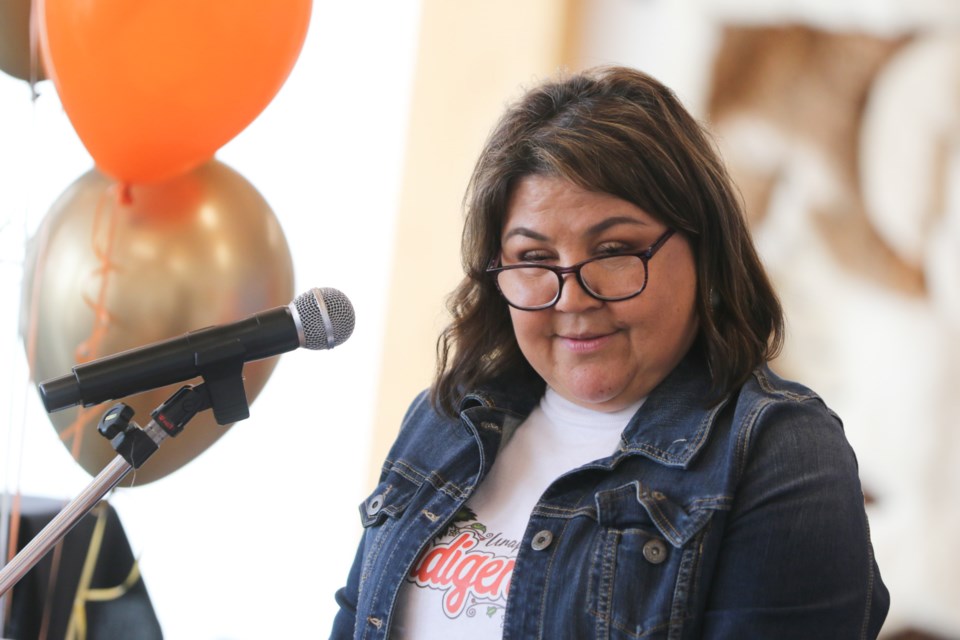 Barbara Nolan's daughter, Colleen Nolan, addresses the crowd gathered at Shingwauk Kinoomaage Gamig during her mother's Anishinaabemowin Children's Video Launch event Aug. 24. 