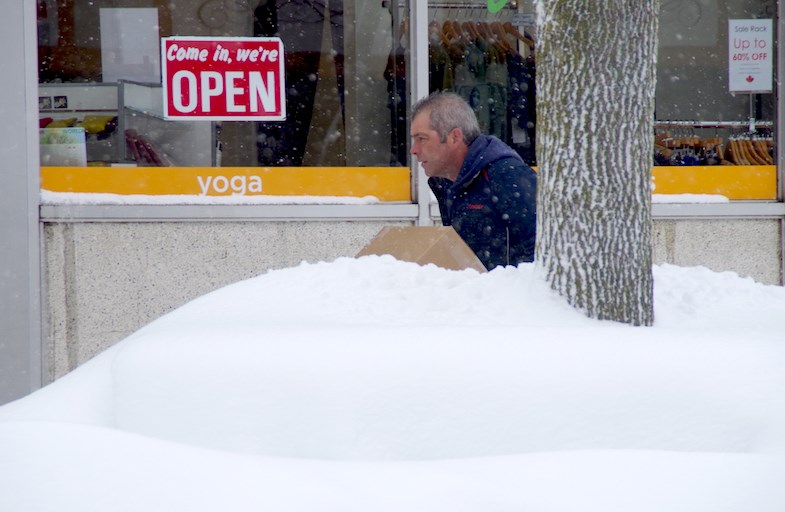 A man is partially hidden by a snowbank as he delivers packages in Sault Ste. Marie, Ont. on Thursday, Nov. 20, 2014. The city got another dumping of snow last night and this morning.
Michael Purvis/SooToday