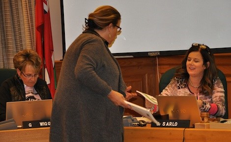 FNMI Lead teacher Carol Trudeau-McEwan (standing) distributed resource materials to Trustees.