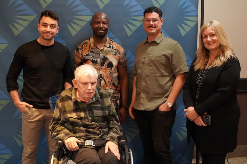 Community Partner Award - David Toppan (left) and Ben Cicchelli (second from right), of Dwellwise, are shown with Baba (Direct Support Professional, CLA) (second from left) and Bill (seated) and Renee Tomasetti (Service Manager, CLA).