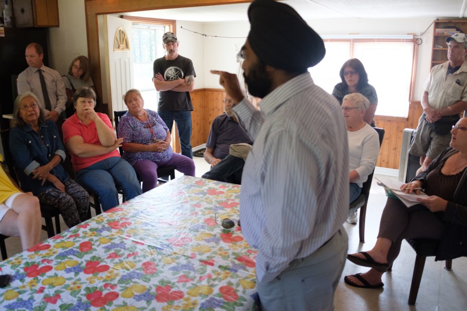 River Valley Park owner Harjeet Dusanjh speaks to residents crammed into the park's office trailer during an emergency meeting on Saturday, just five days before a forced closure by Algoma Public Health is supposed to take effect. Jeff Klassen/SooToday