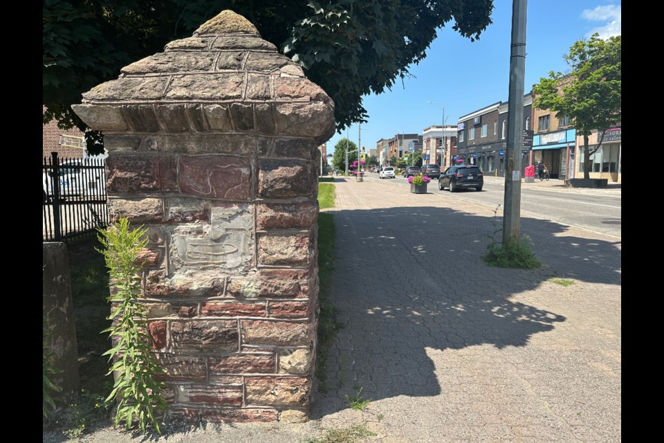 Glue marks are all that remain of a historical plaque that was once set into this stone column on Queen Street East, near Bruce Street. The plaque commemorated the International Hotel, which once stood on the site.