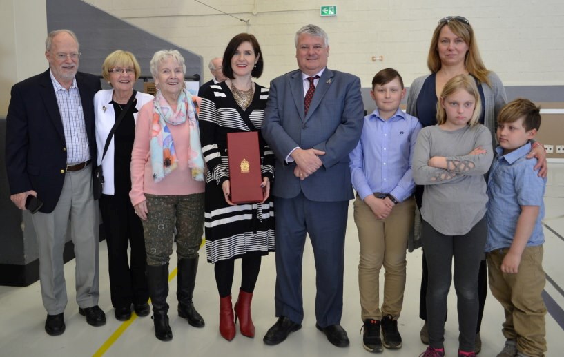 Photo provided: Preparing to place the Peace Tower Flag, in the Memorial Cabinet, L-R Walt Sutherland, Lynn Sutherland, Priscila Arnott, Allison Arnott, hold Peace Tower Flag, MP Terry Sheehan, Mac Fenchak, (back) Karen Fenchak, Anya Fenchak, Matthew Fenchak. Photo Credit: Peter Grant
