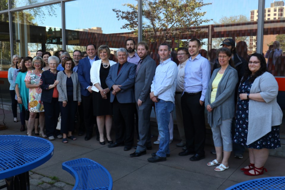 Community stakeholders for the Sault Ste. Marie Public Library archive project gather for a group photo during Friday's federal funding announcement at James L. McIntyre Centennial Library. James Hopkin/SooToday