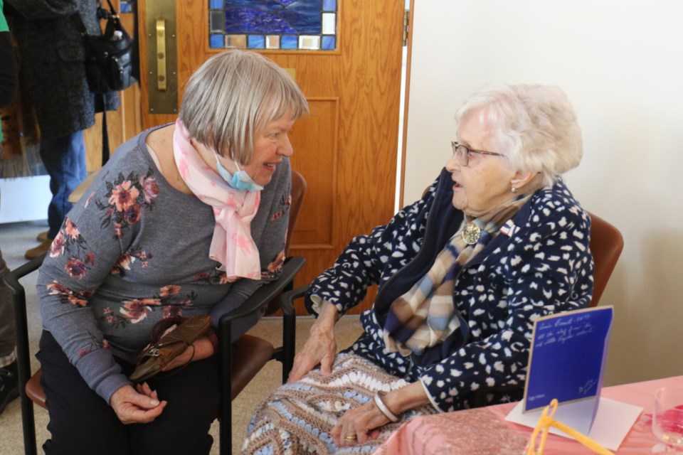 Soon-to-be centenarian Kay McMaster, right, visits with one of her many well-wishers during her 100th birthday celebration on Saturday. 