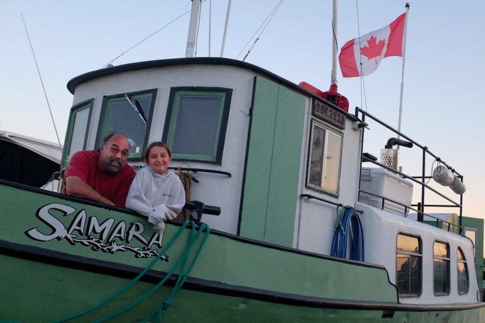 Marc Mousseau and his granddaughter Samara, on the 75-year-old tugboat Moussaeu named after her. Photo by Jeff Klassen for SooToday