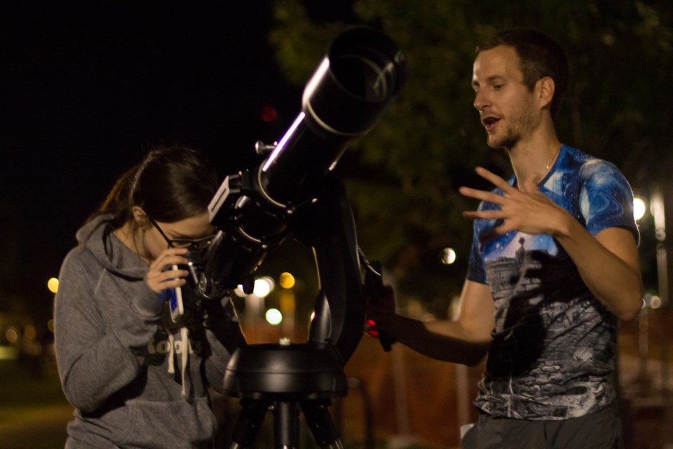 For the last two years Tasz has been spending his spare evenings hanging out on the waterfront boardwalk with his telescope. Since the Pokémon Go craze hit he's been setting up in Clergue Park to draw from them increased night time activity. Photo by Jeff Klassen for SooToday