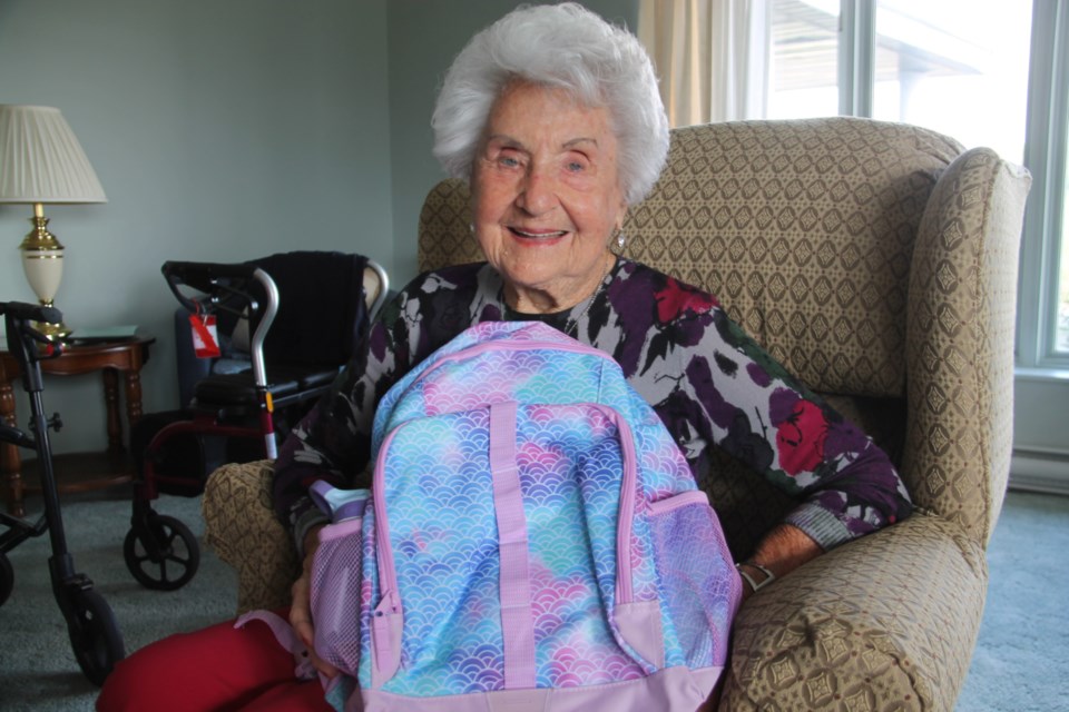 Reva Ovens, Pathways Retirement Residence senior, with a new backpack filled with back to school supplies for needy children, Aug. 25, 2023