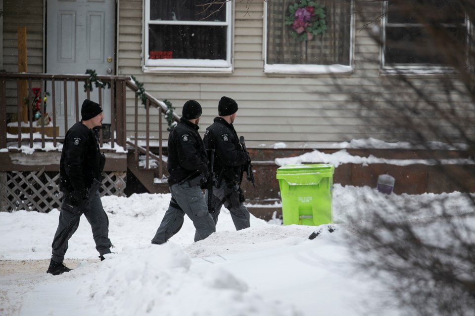 Armed officers leave an address in the 600-block of Albert Street after the scene was held by Sault Ste. Marie Police Service on Jan. 12, 2022.