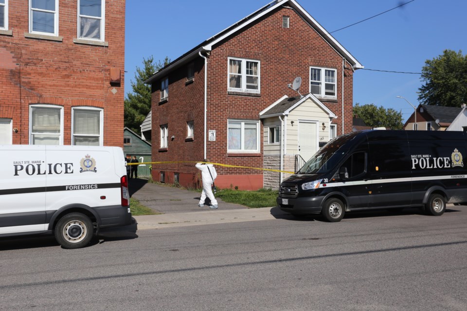 A forensics team on scene at a multi-unit residence on John Street near Cathcart Street on Saturday, Sept. 9, two days after 22-year-old Taylor Marshall was found dead inside.