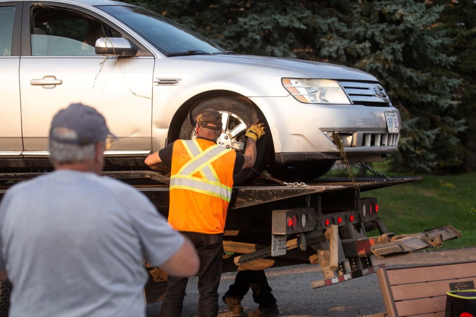 River weeds hang from a Ford Taurus that accidentally drove into the water at Bellevue Marina on Wednesday afternoon. A woman was rescued by firefighters who were training nearby and no one was reported injured.