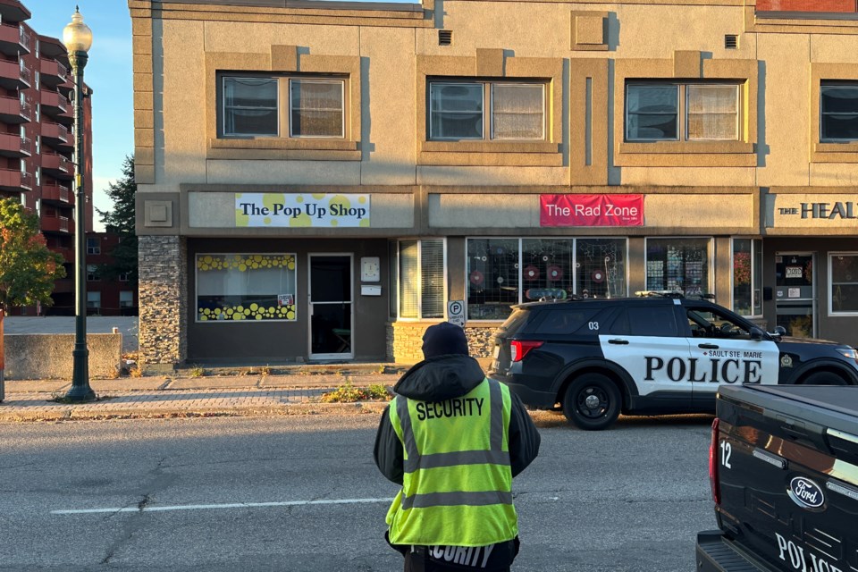 Downtown security on the scene of a broken front door at the Pop-Up Shop in downtown Sault Ste. Marie. A vacant shop directly across the street had similar damage at the same time.