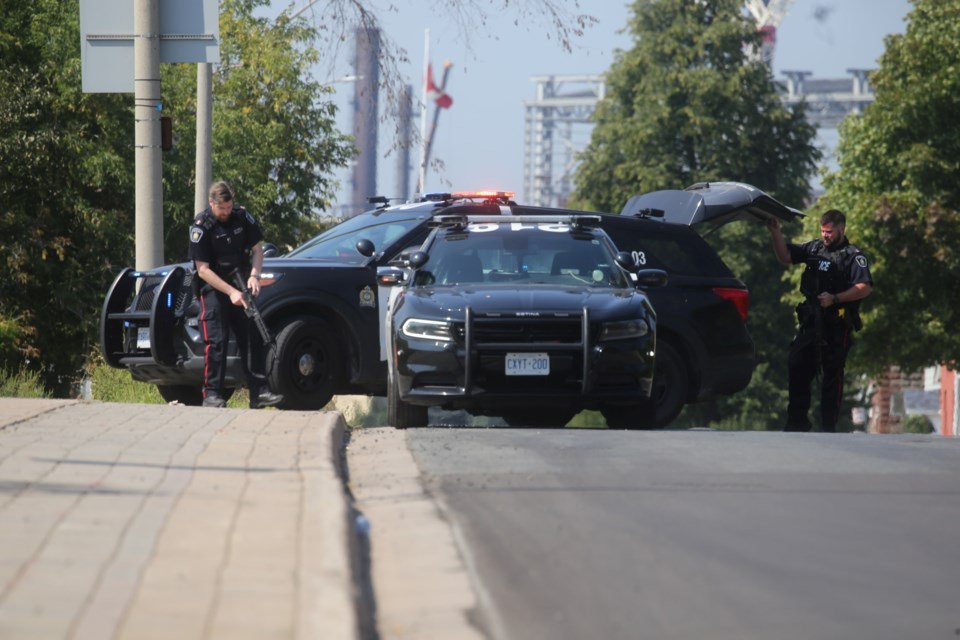 Officers with the Sault Ste. Marie Police Service on Queen Street after responding to a scene on George Street near the International Bridge on Sept. 5, 2023..