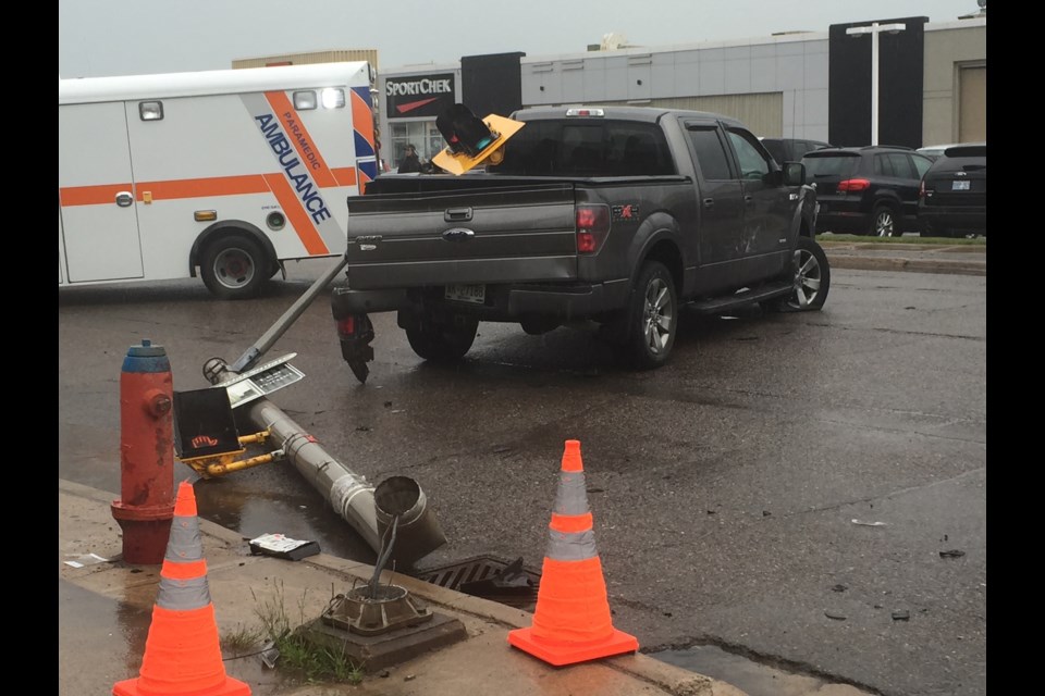 A damaged pickup truck is pictured on Bay Street following a collision that has closed Dennis Street and reduced Bay to three lanes. Kenneth Armstrong/SooToday