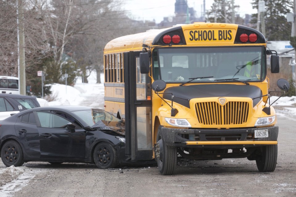 Police respond to the scene of a collision involving a school bus at Wilcox Avenue and Maple Street on Friday, April 1, 2022