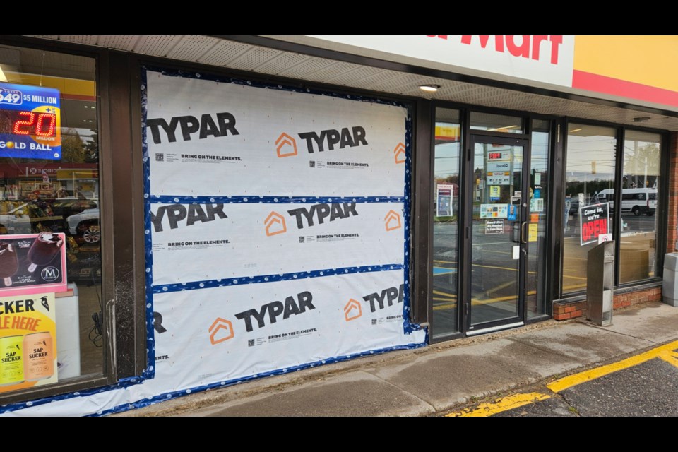 The front of the store is now boarded up, but it is open