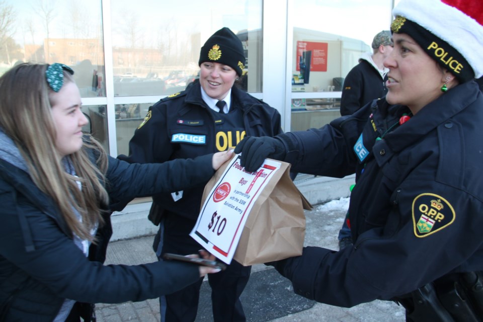 Sault OPP officers collected donations of non-perishable food and other items for the Soup Kitchen at Rome's Your Independent Grocer for the annual OPP Stuff a Cruiser event, Dec. 2, 2023.