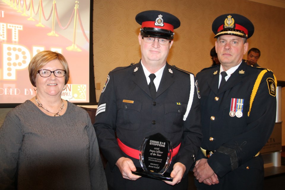 Sault Ste. Marie Police Services Officer of the Year Sergeant Brent Ralph with Robert Keetch, Sault Police Services chief, and Maureen Webb, Station Mall (award sponsor), May 16, 2016. Darren Taylor/SooToday