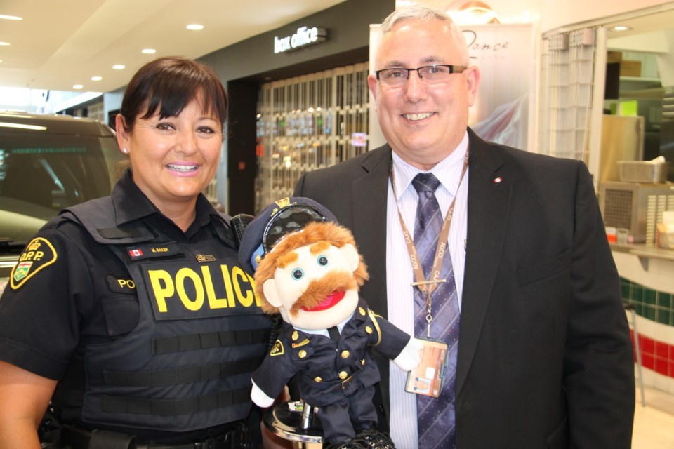 Monique Baker, Sault OPP Constable, and Wes Moore, retired Sault OPP detachment commander, with Constable DunlOPP at Police Day 2016 at Station Mall, May 17, 2016. Darren Taylor/SooToday