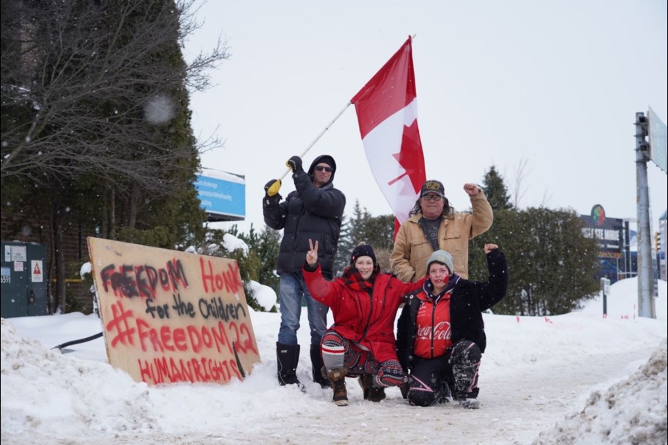 A demonstration near the entrance of the Sault Ste. Marie International Bridge shortly after 2 p.m. today. Front: Merissa Dinner, Tasheena Nielsen. Back: Man who chose to remain anonymous, Mike Cyr