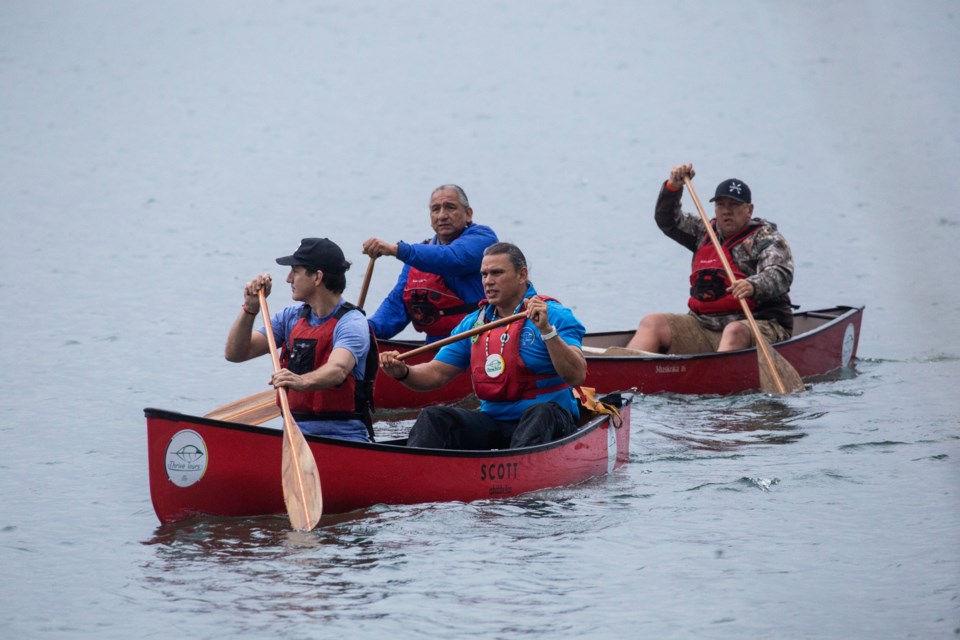 Prime Minister Justin Trudeau canoes with local Indigenous leaders (L-R) former chief Dean Sayers of Batchewana First Nation, Brad Robinson CEO and owner Thrive Tours and Chief Mark McCoy of Batchewana First Nation on the St. Marys River in Sault Ste Marie on Friday, August, 30, 2024. THE CANADIAN PRESS/Kenneth Armstrong