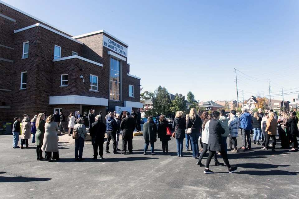 A crowd gathered at the Community Resource Centre for a ribbon-cutting event on Monday.