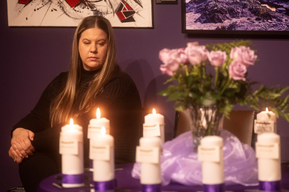 Sarah Paciocco, Women In Crisis sexual assault and abuse crisis counsellor, looks toward the candles representing the 14 women killed Dec. 6, 1989 during the Montreal massacre.