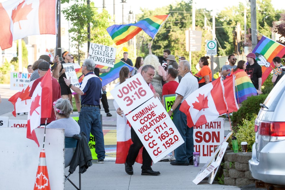 A group led by Tim Coderre (centre) staged its third day of protests in a row against the Sault Pride community with a demonstration on Canada Day at the Pride crosswalk on Spring Street. 