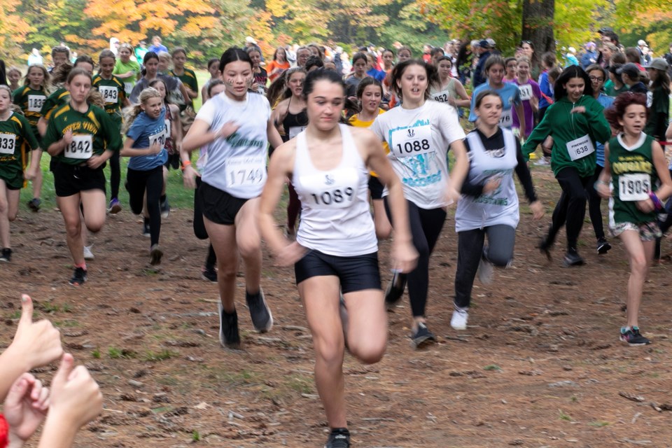 Runners receive thumbs up from spectators at the city elementary school cross-country running meet held on Wednesday.