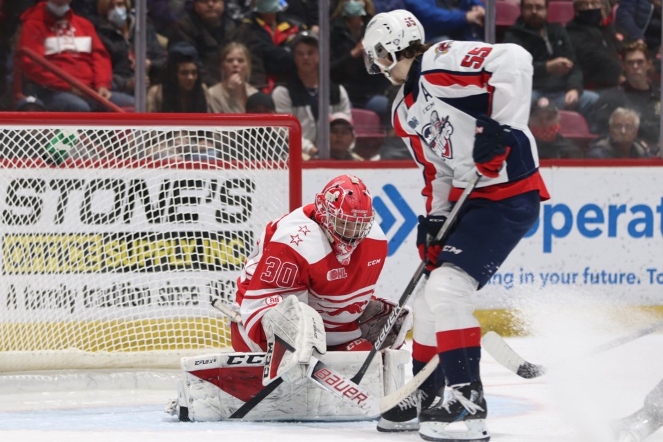 Soo Greyhounds goaltender Tucker Tynan stops Windsor Spitfires forward Wyatt Johnson on a breakaway in a game at the GFL Memorial Gardens on March 26, 2022.