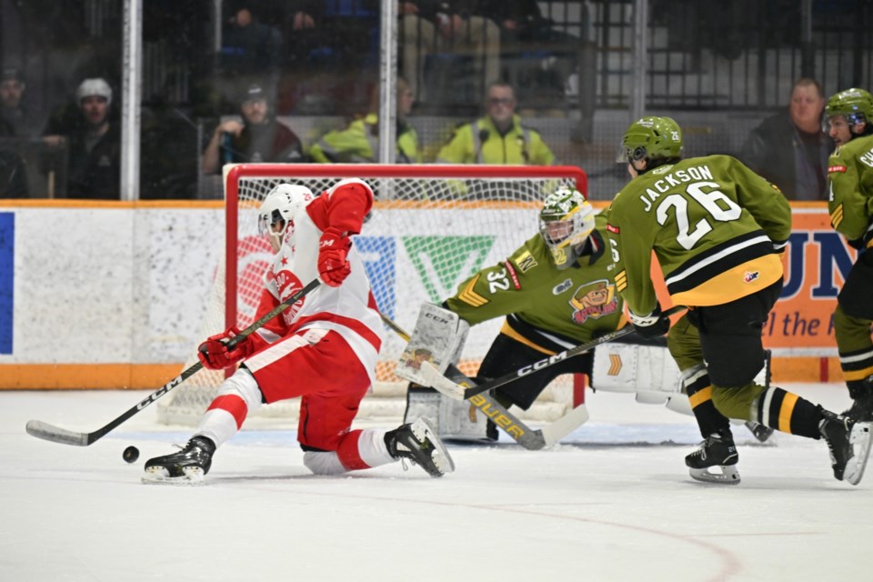 Soo Greyhounds forward Kalvyn Watson beats North Bay Battalion goaltender Charlie Robertson during a game at the North Bay Memorial Gardens on Jan. 12, 2023.