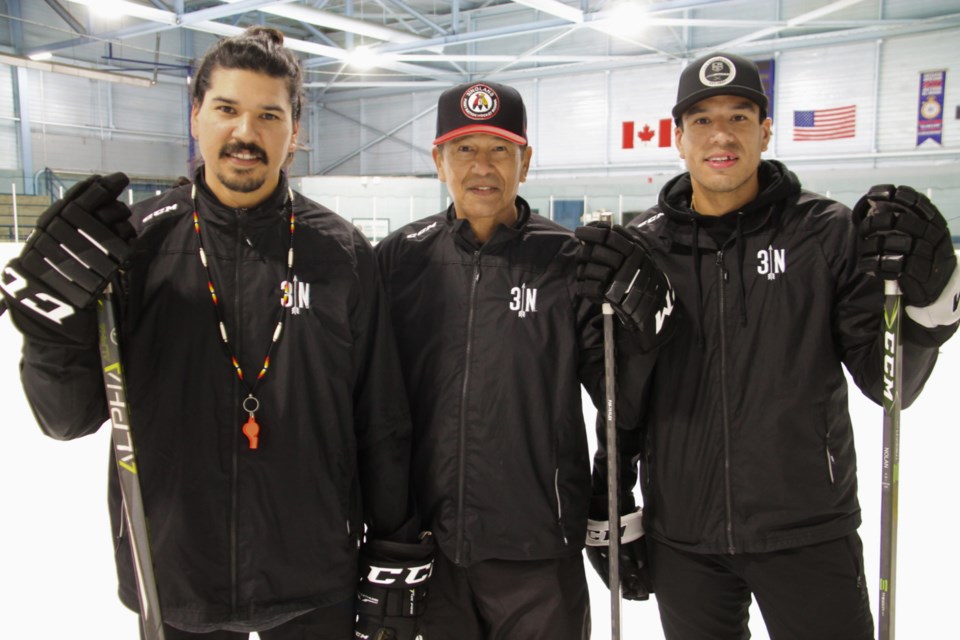 Ted Nolan, with sons Brandon (left) and Jordan (right) at the Three Nolans hockey school for Indigenous children and teens at the John Rhodes Centre, August 10, 2024.