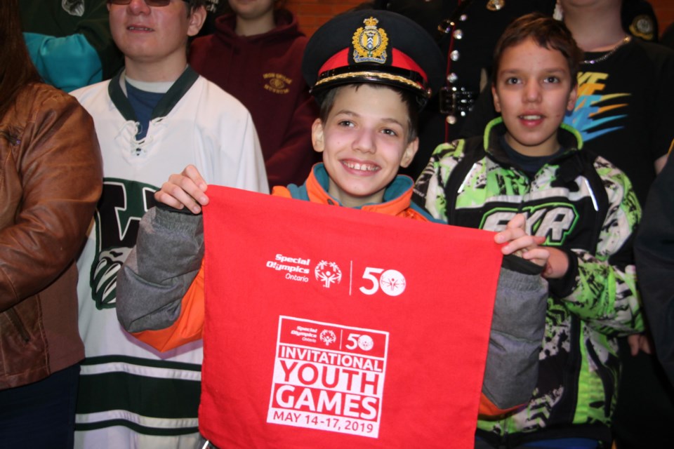 Colin Burgan, 15, a St. Basil Catholic School student looking forward to playing basketball in the 2019 Special Olympics Ontario Invitational Youth Games in Toronto in May, borrowed Sault Police Chief Hugh Stevenson’s hat for a group photo of local Special Olympics athletes, March 25, 2019. Darren Taylor/SooToday  