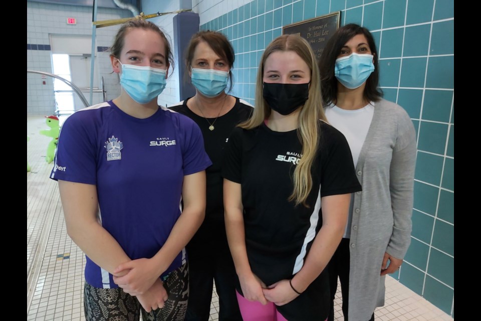 Sault Surge Aquatic Team swimmers Kaelyn Albert and Haley MacFarlane with Nancy Day, Sault Surge head coach and Franca Broadbent, Sault Surge president, prior to the team’s first meet at John Rhodes Community Centre Pool since 2020, March 5, 2022