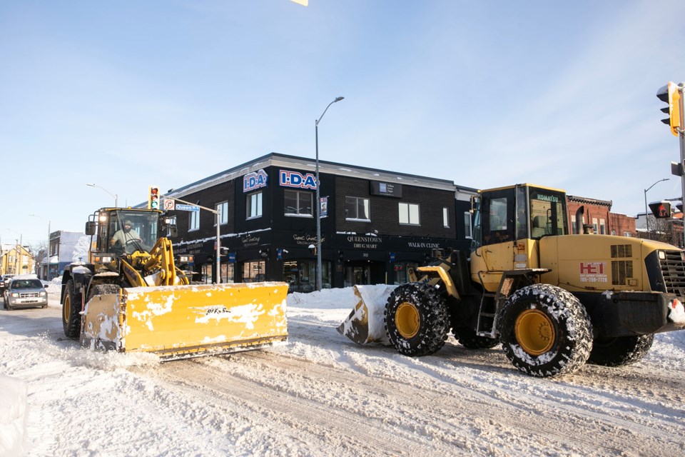 Some heavy machinery pass each other at Bruce and Queen streets.