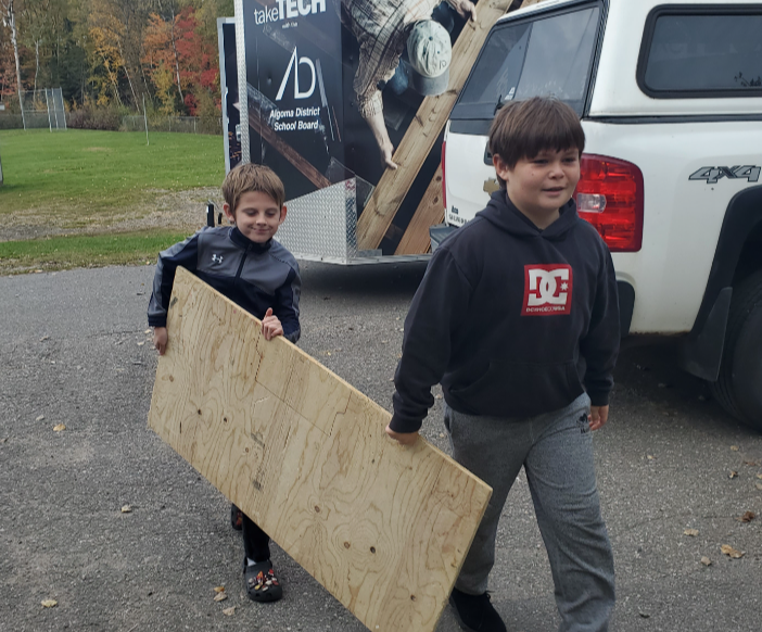 photo-1-kiwedin-2boys-carry-plywood(1)