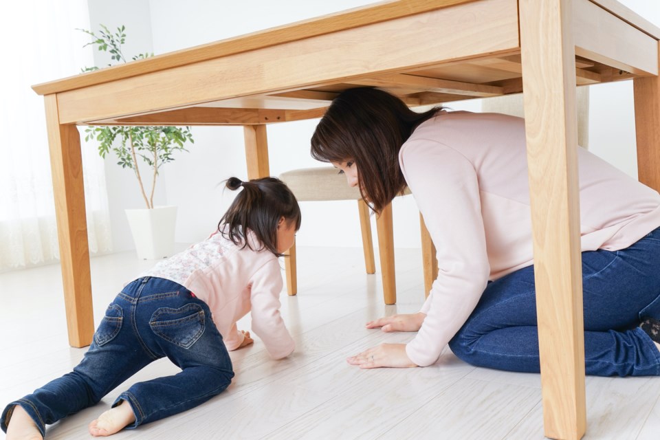 A parent and child huddling under a table Squamish10