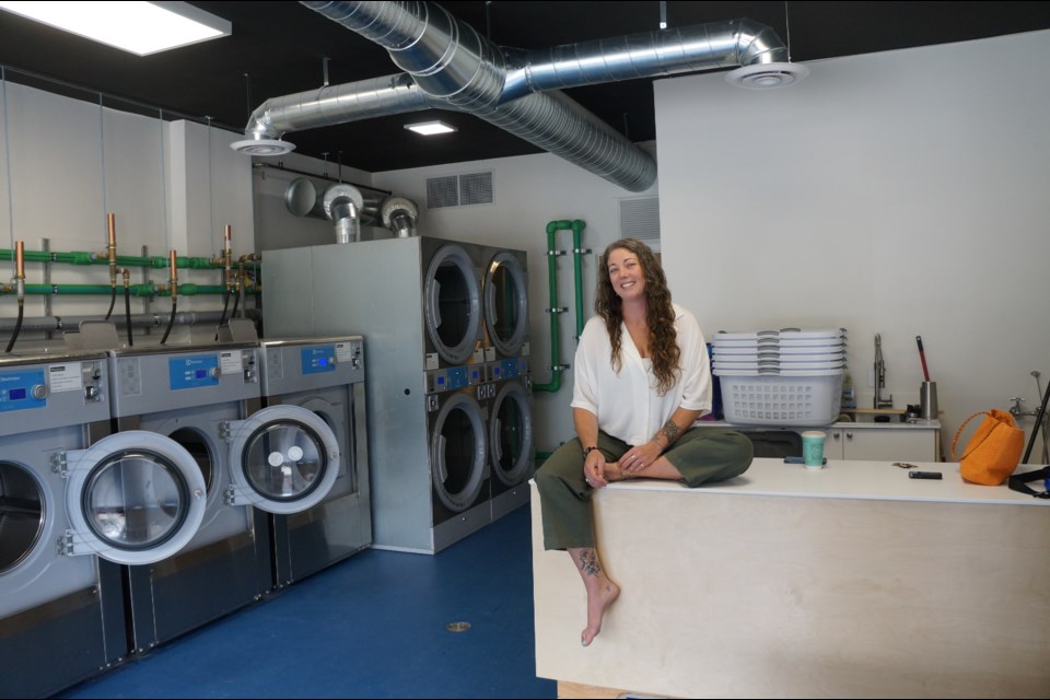          Ashleigh Leier, owner of  The Spot Laundromat, at her new location on Friday. The laundry is set to re-open on Monday (June 3)                       
