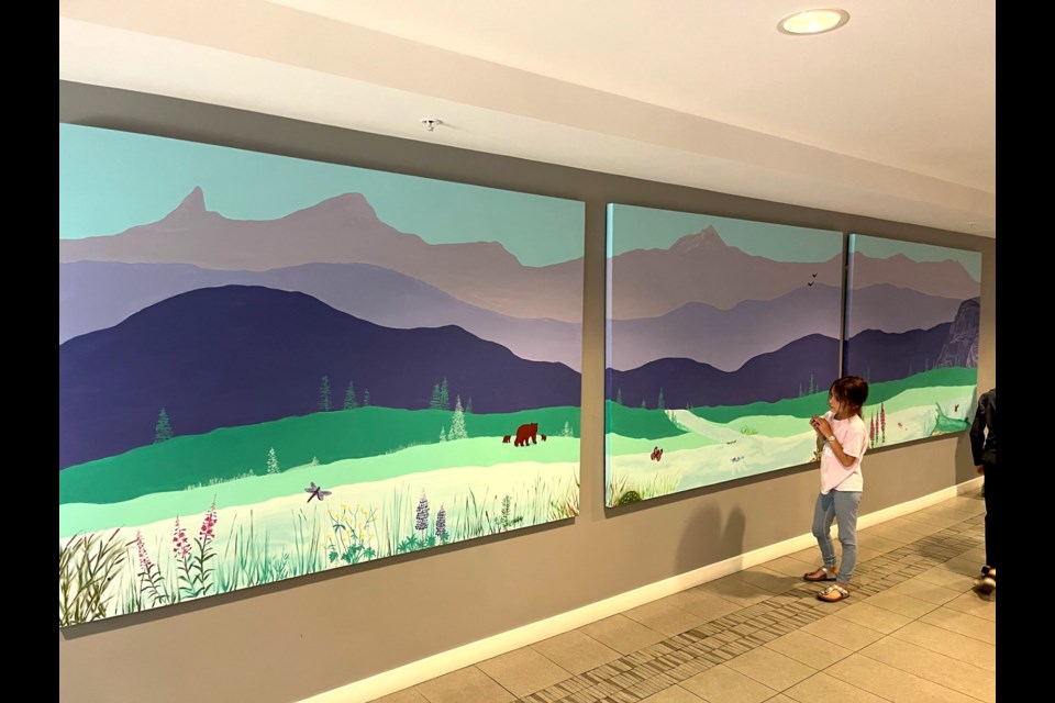 Several local artists unveiled a canvas mural painted in the lobby of the Aqua building in downtown Squamish on Wednesday, June 14.