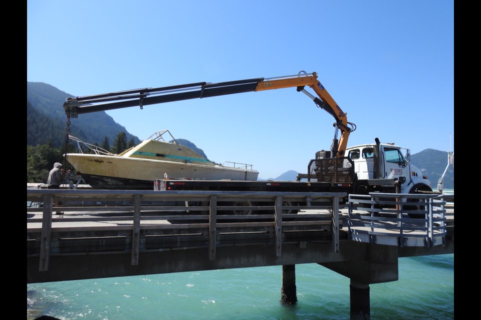 The boat being removed from under Porteau Cove pier on July 15.