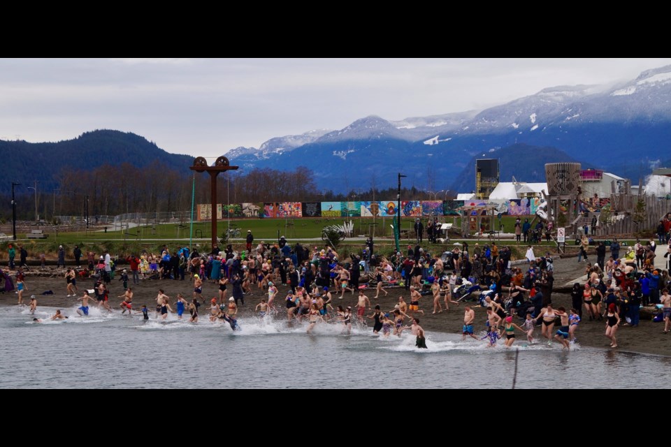 Hundreds braved the cold air and water to welcome in 2025 at Sp'akw'us Feather Park at noon today.