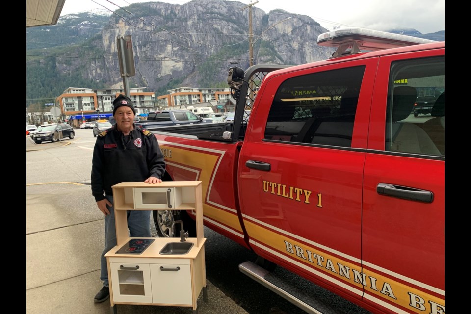 On Dec. 20, Britannia Beach Volunteer Fire Department Fire Chief Rob Nicholls slides the Ikea play kitchen out of the back of a department pickup outside The Squamish Chief.