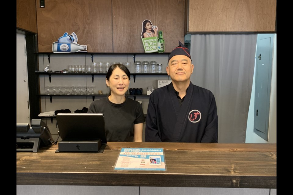 Co-owners, Dan Kwak (right), and Ikuko Bass at Blue House: Korean Buffet and Sushi, before the restaurant opened on Thursday, July 25.