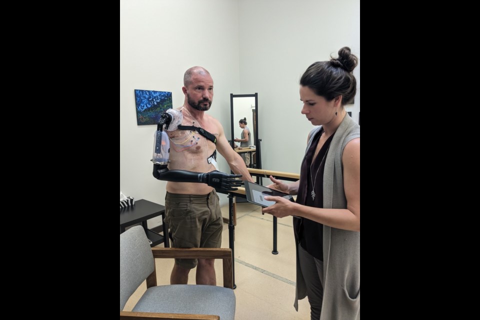 Sean Roberts and Tania Chabot with his new prosthetic arm.