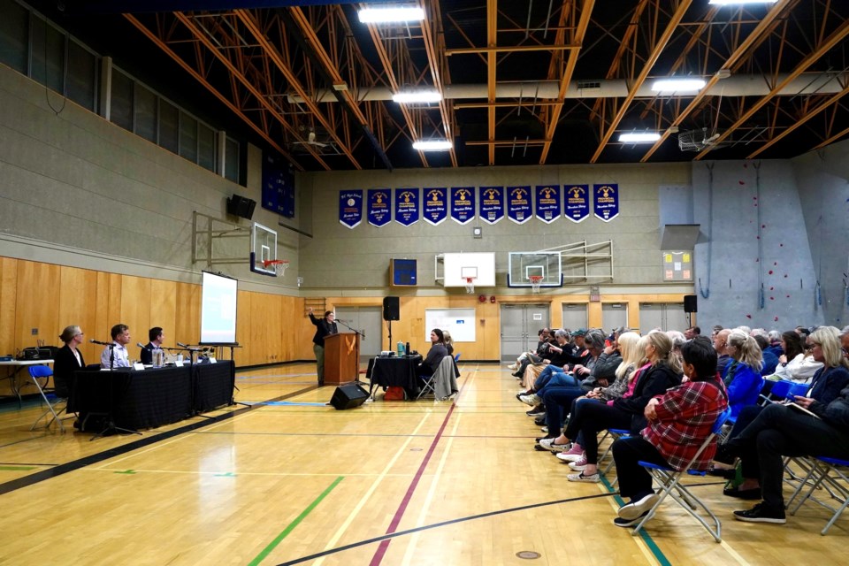 The candidates Jen Ford, Jeremy Valeriote, Yuri Fulmer in front of an attentive audience at Don Ross Middle School on Wednesday night.