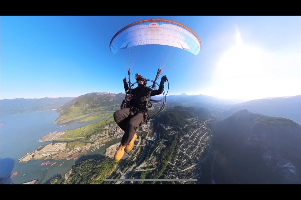 Cody Bandsma, a powered paraglider pilot from Salmon Arm, flies over Squamish, in July.