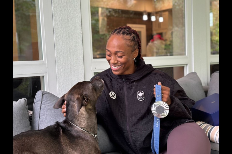 Charity Williams, with her dog,  Arya, in Squamish on Monday.