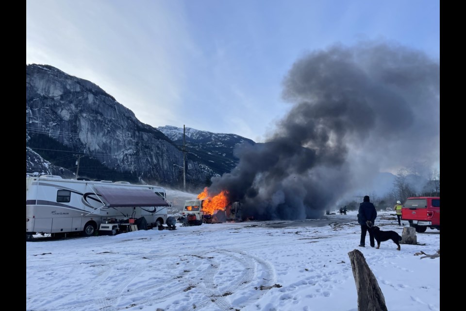 Smoke can be seen billowing from an RV.